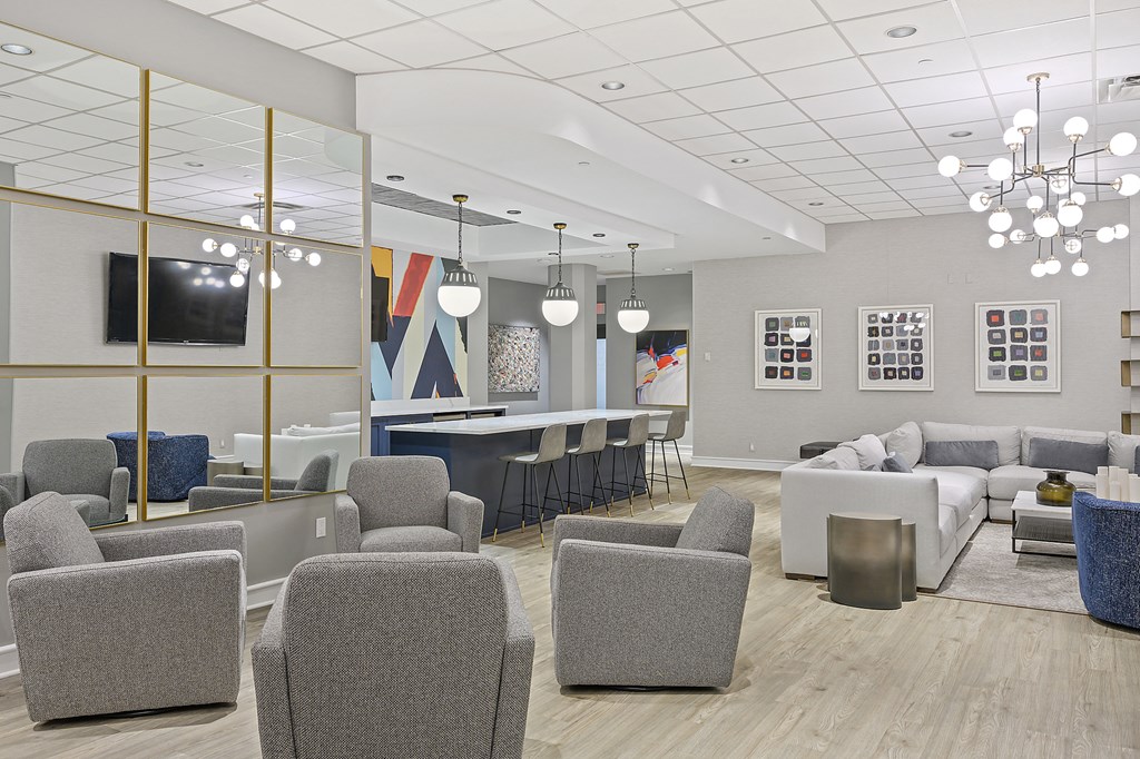 a rendering of a lobby with couches chairs and a bar