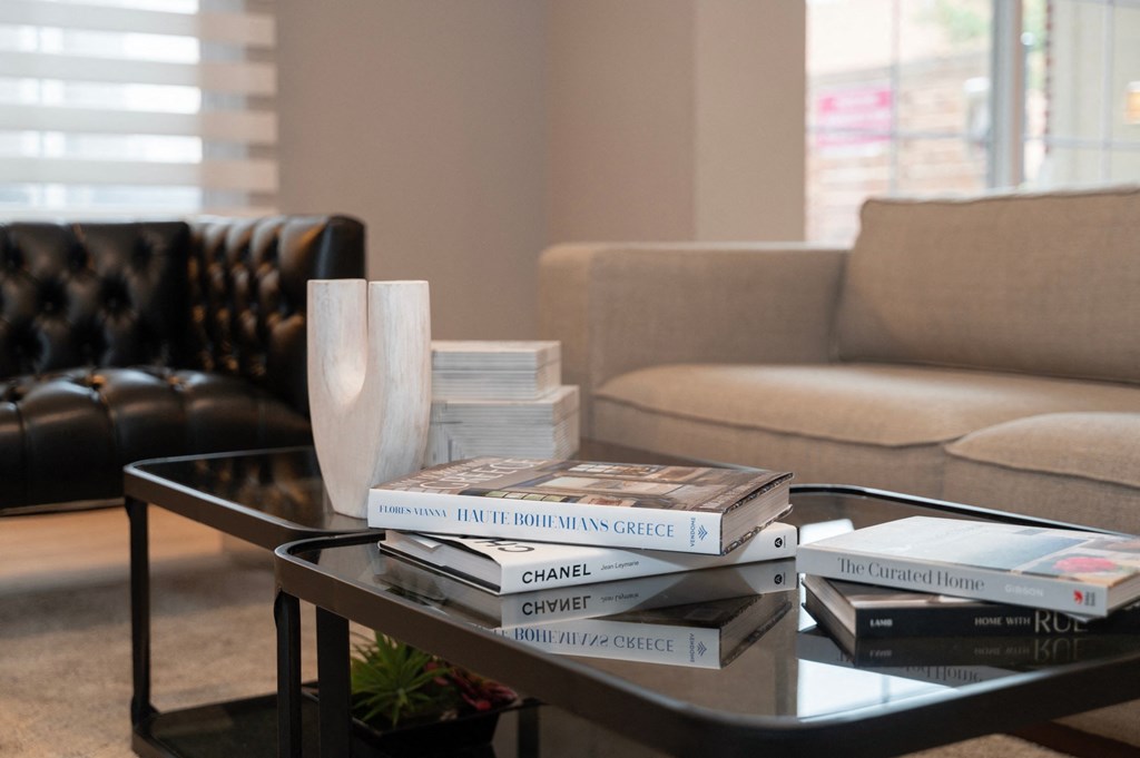 a pile of books on a coffee table in a living room at Monmouth Row Apartments, Kentucky