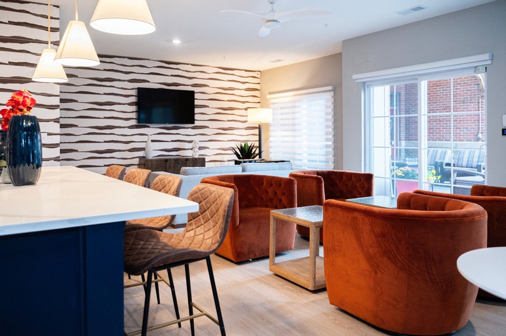 a living room with chairs and a table and a tv at Monmouth Row Apartments, Newport, 41071