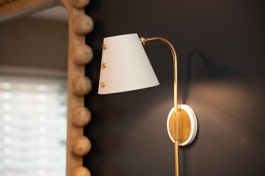 a lamp with a white lamp shade and a mirror at Monmouth Row Apartments, Newport, 41071