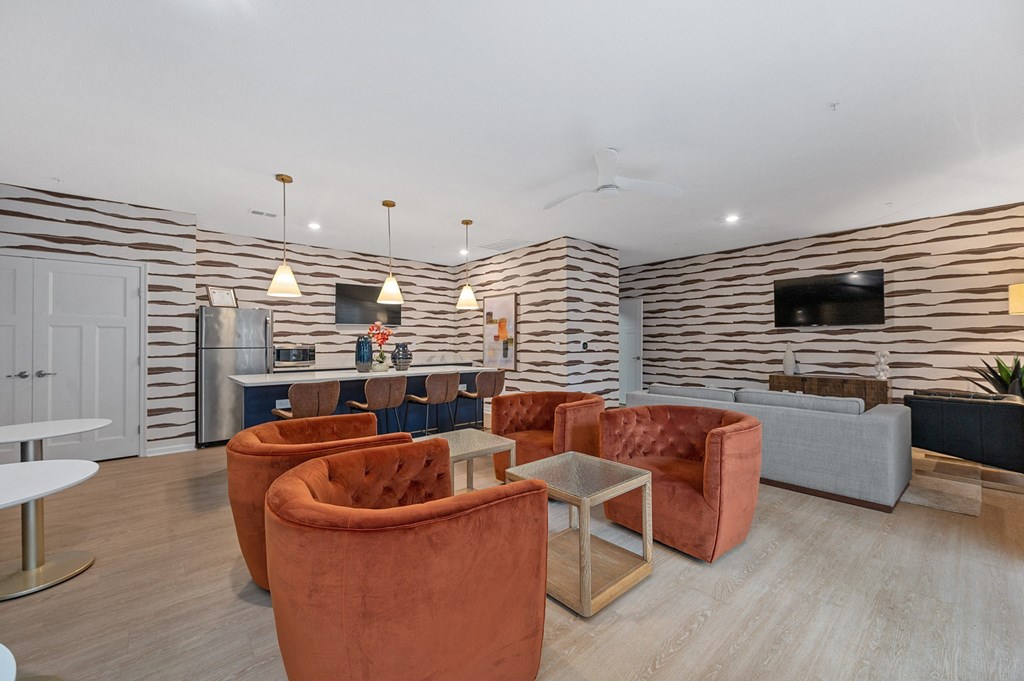 a living room with couches and chairs and a kitchen at Monmouth Row Apartments, Kentucky