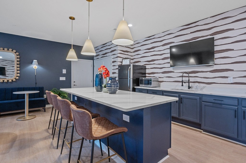 a bar with a table and chairs in a room at Monmouth Row Apartments, Newport, KY