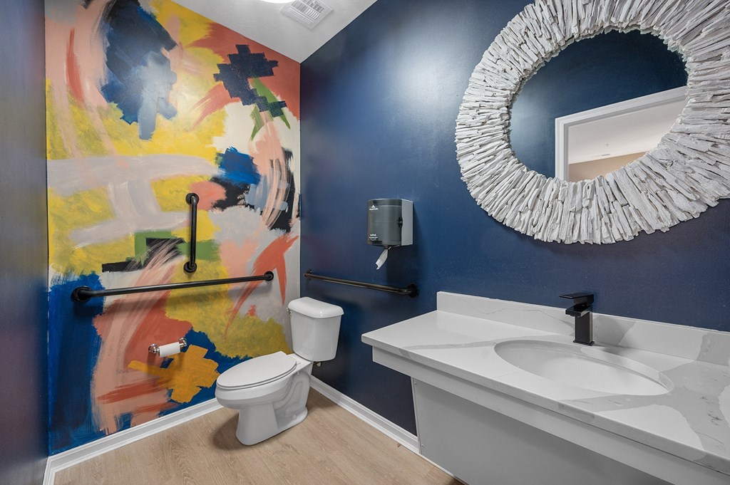 the residence on lamar apartment bathroom with sink toilet and mirror at Monmouth Row Apartments, Newport, Kentucky