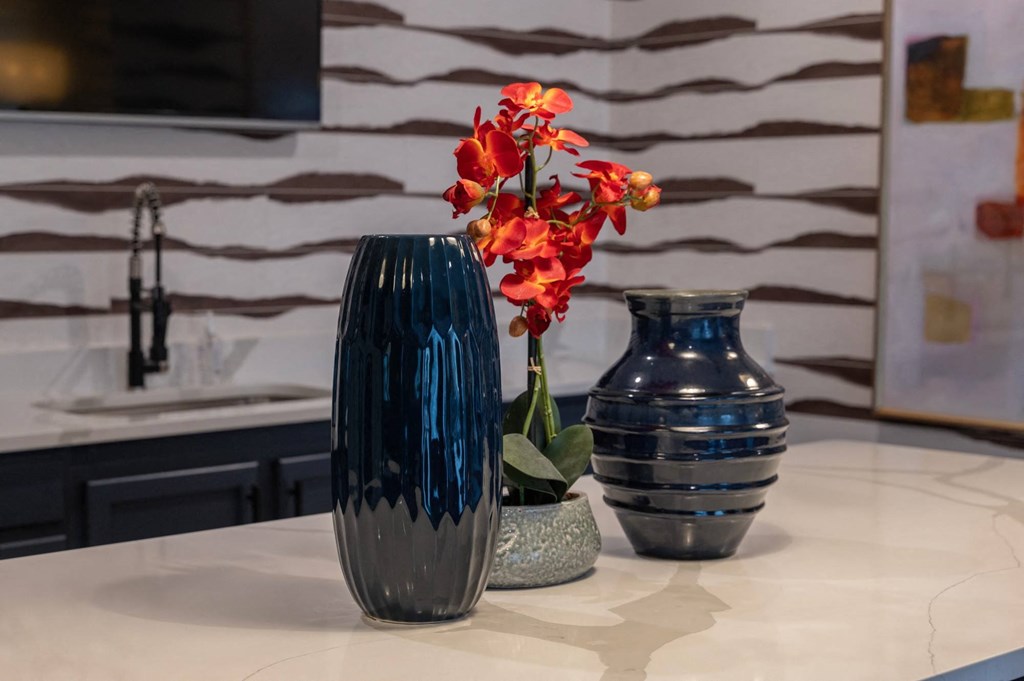 three vases sitting on a table with flowers at Monmouth Row Apartments, Newport, 41071