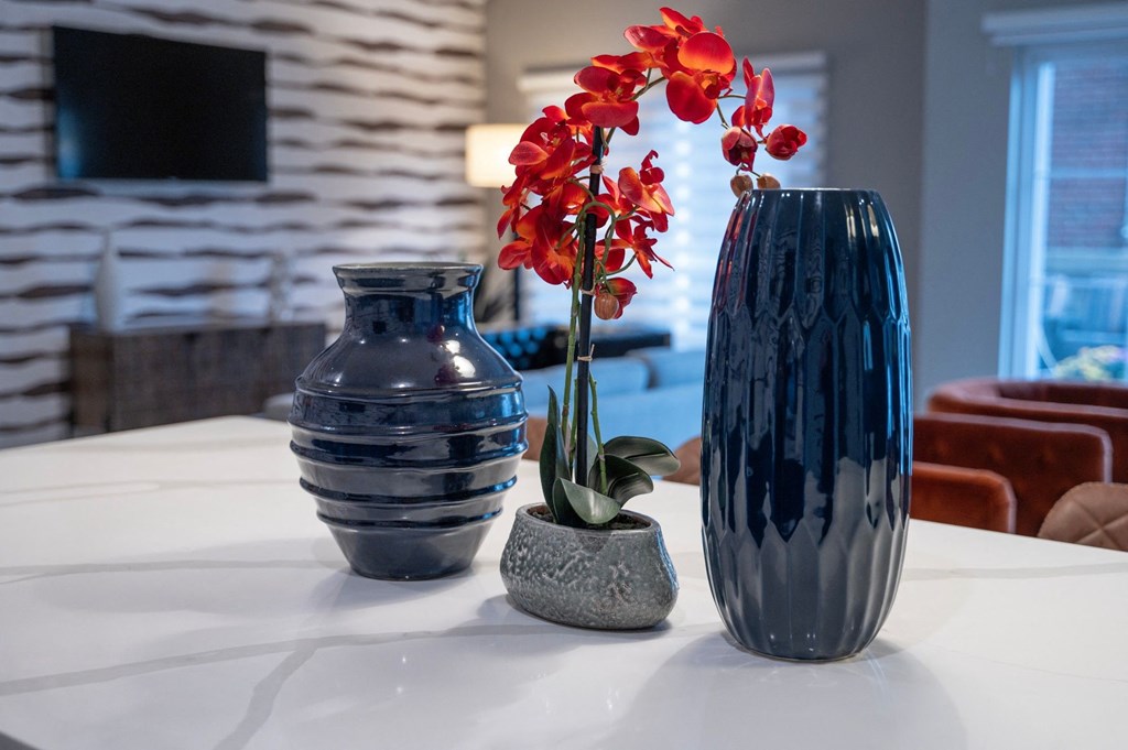 three vases and a flower on a table in a living room at Monmouth Row Apartments, Newport, 41071