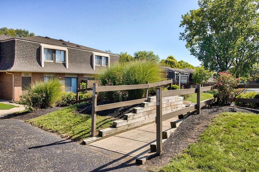 A residential area with houses and a wooden fence.