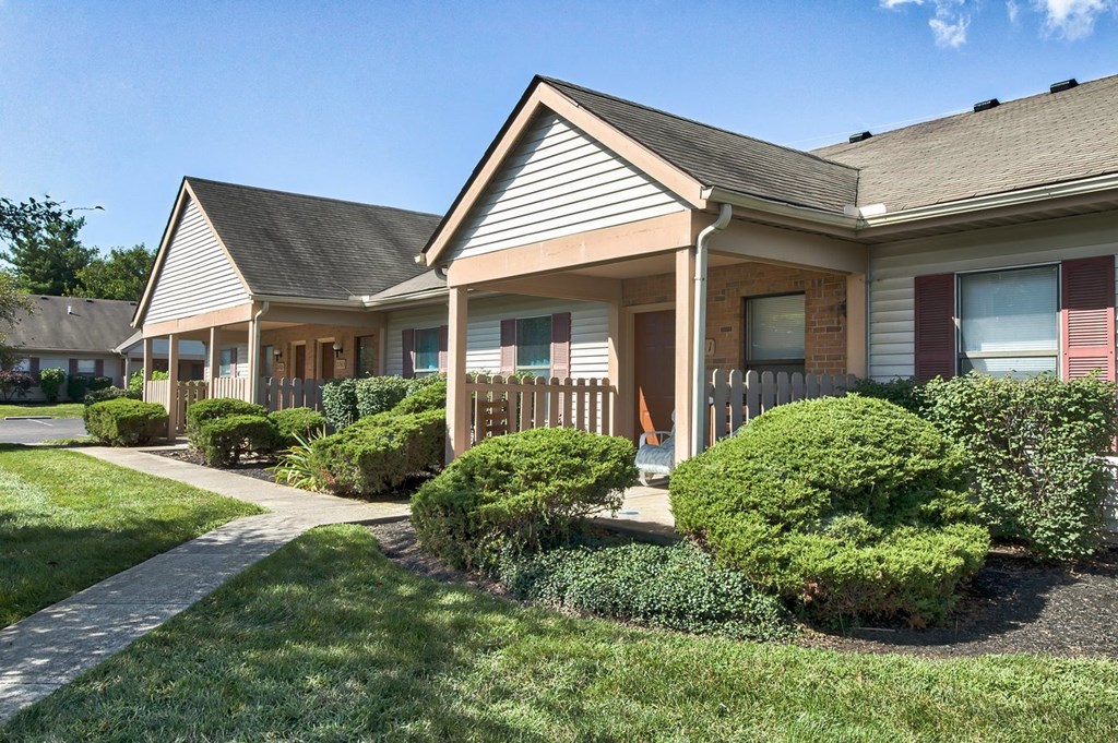 A house with a grey roof and a brown fence.