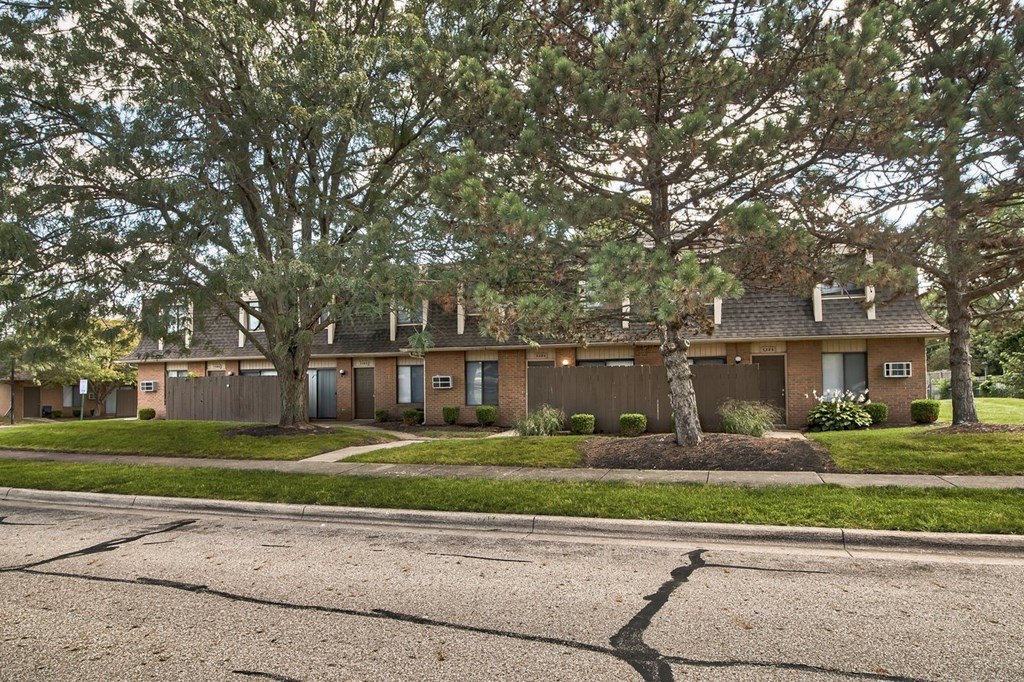 A tree in front of a house.