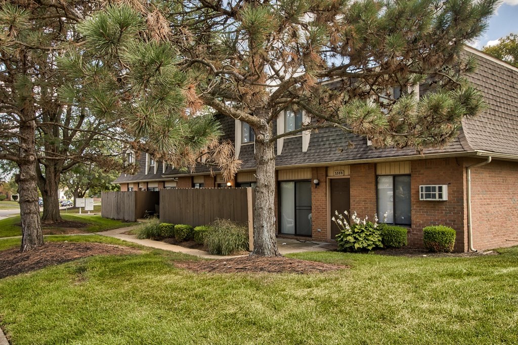 A tree in front of a house.