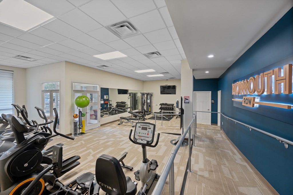 A gym with exercise equipment and a sign that says "MORNINGOUT".