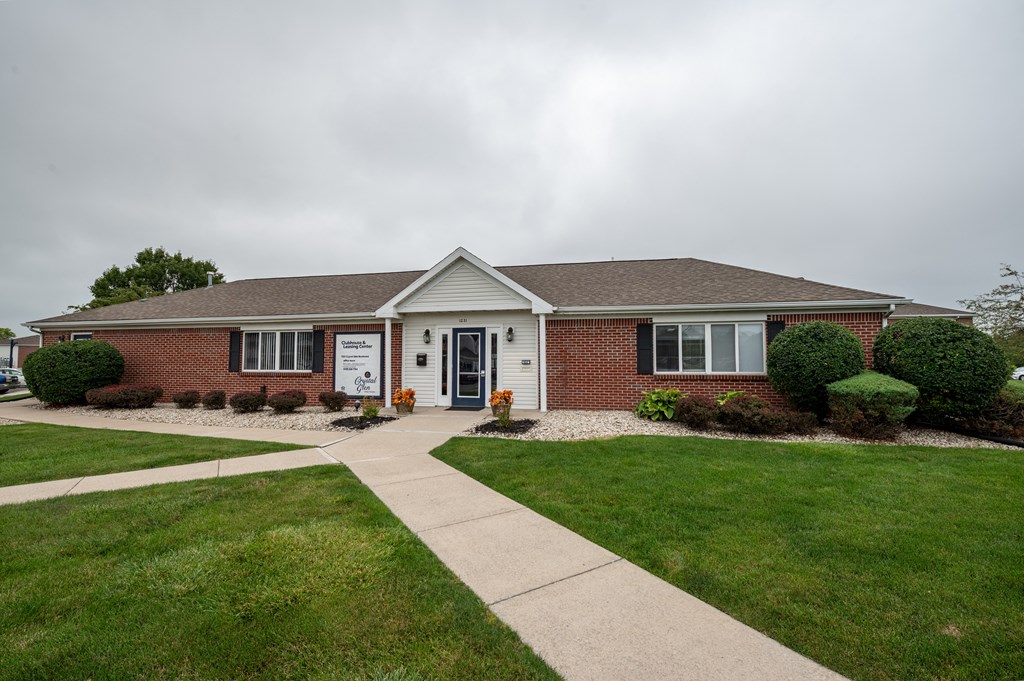 a brick house with a sidewalk in front of it at Crystal Glen Apartments, Findlay, OH