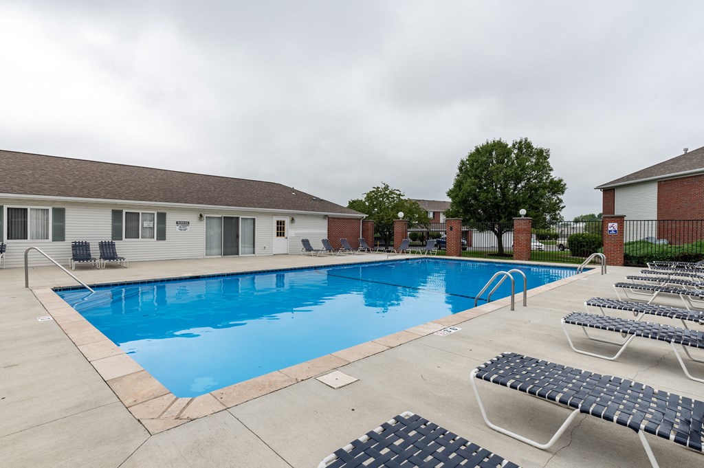 our apartments have a large swimming pool with lounge chairs at Crystal Glen Apartments, Findlay, Ohio