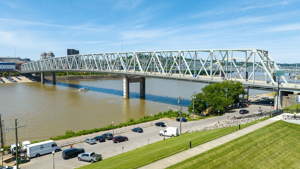 a view of a bridge over the river with cars driving under it