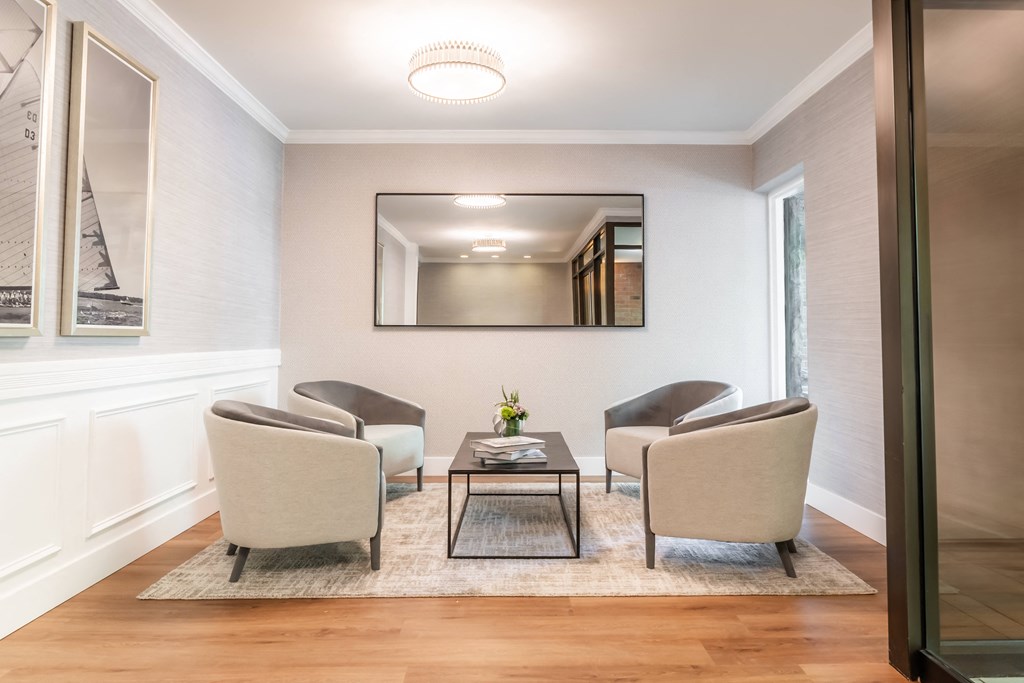 a living room with chairs and a coffee table and a mirror at Indian Creek Apartments*, Cincinnati, OH