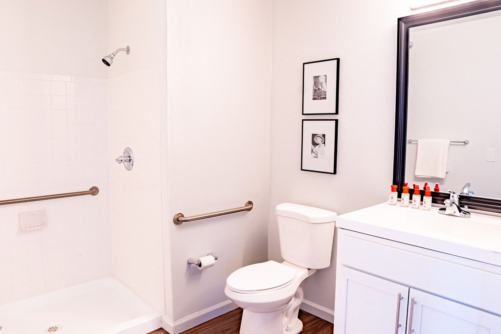 a bathroom with a white toilet next to a white bathtub
