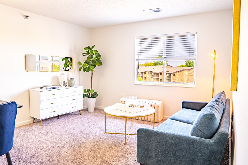 a living room with a couch coffee table and dresser