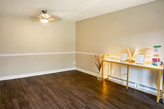 an empty room with a table and a ceiling fan - Photo Gallery 2