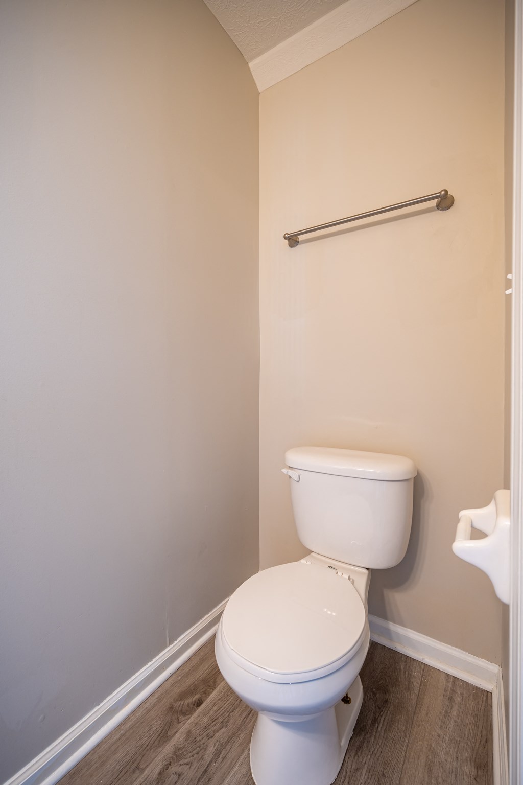 an empty bathroom with a toilet and a grab bar at Traditions at Slate Ridge, Ohio