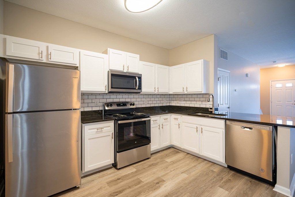 an empty kitchen with stainless steel appliances and white cabinets at Traditions at Slate Ridge, Reynoldsburg Ohio