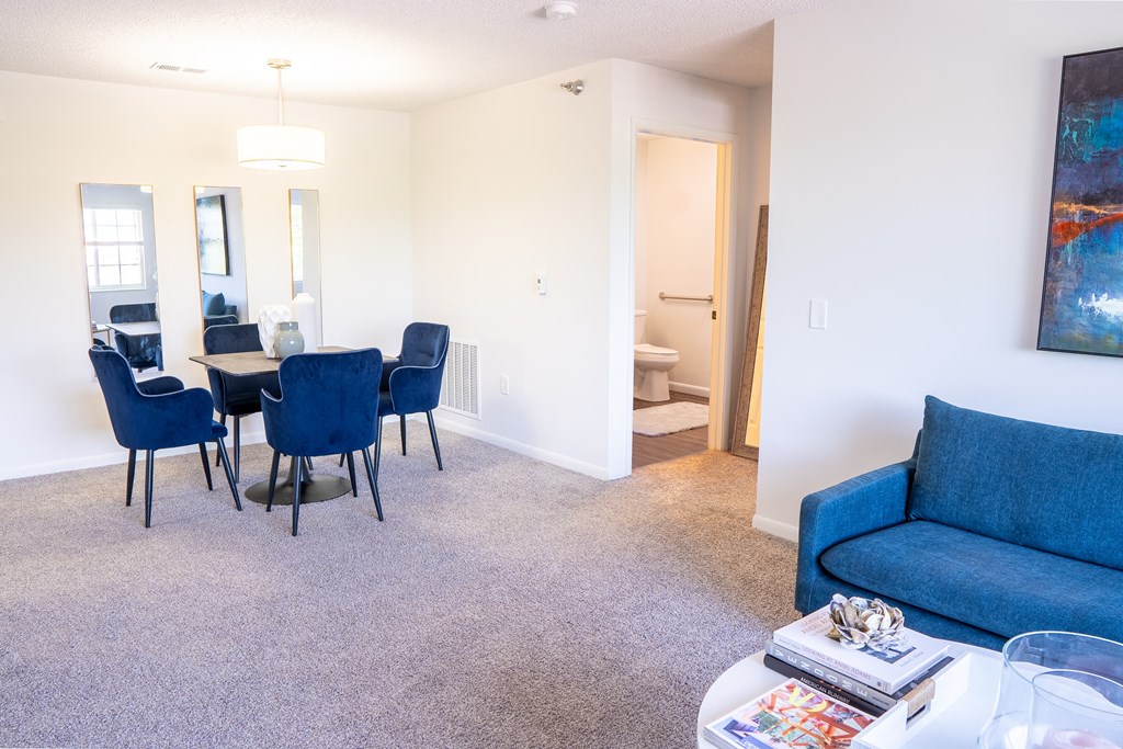 a living room with a couch and a table with chairs