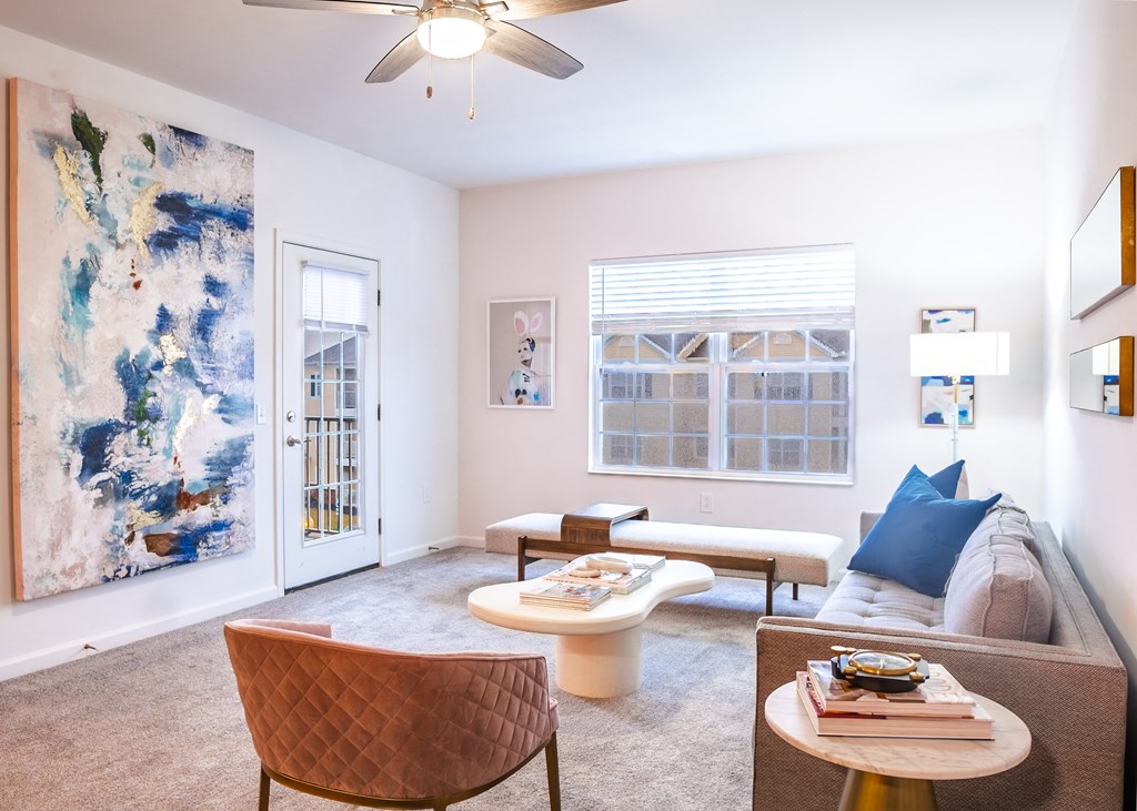 a living room with pink walls and a ceiling fan  at Waterstone Landing, Perrysburg, Ohio