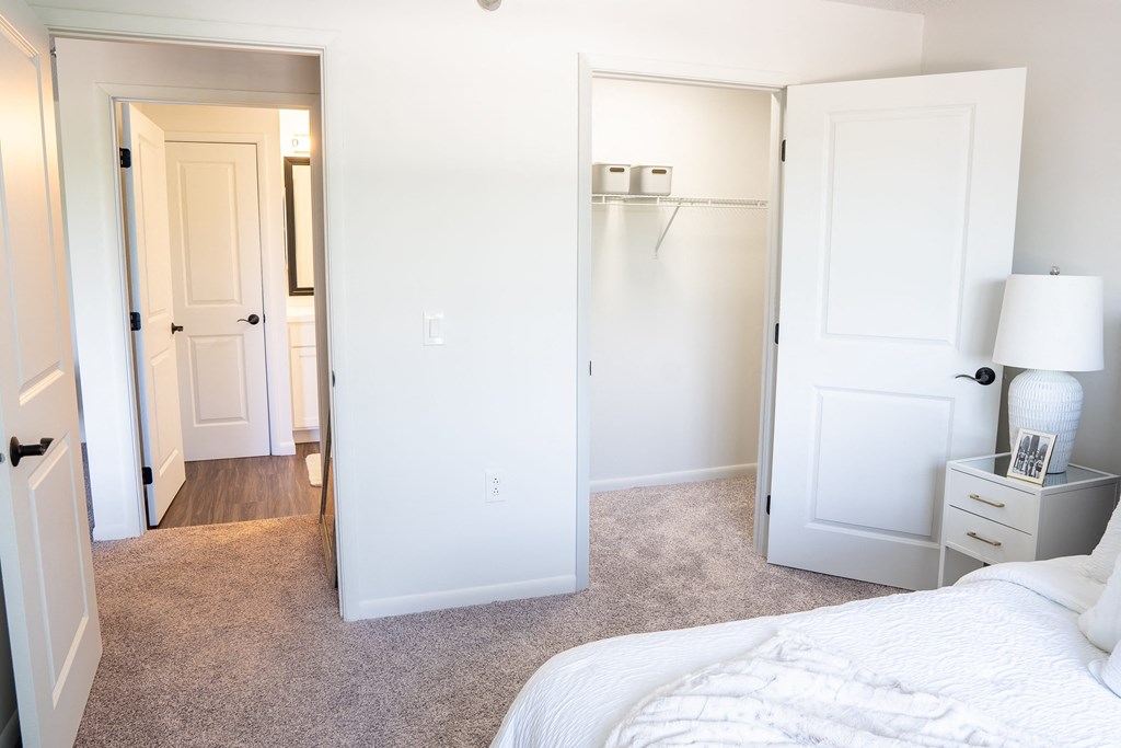 a bedroom with white walls and carpet