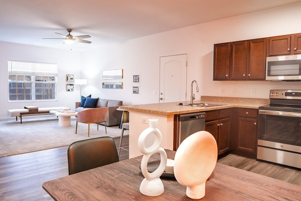 a kitchen and living room with a table and chairs and a ceiling fan  at Waterstone Landing, Perrysburg