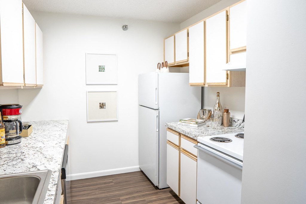 a kitchen with white appliances and wooden cabinets