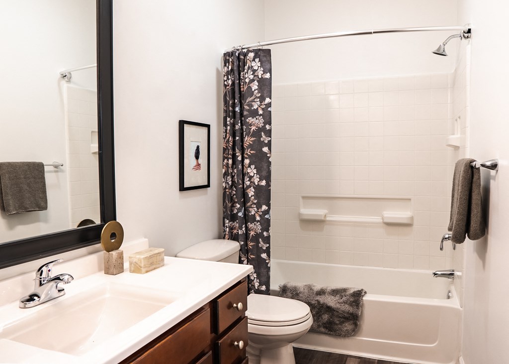 a bathroom with white fixtures and a black and white shower curtain  at Waterstone Landing, Ohio, 43551