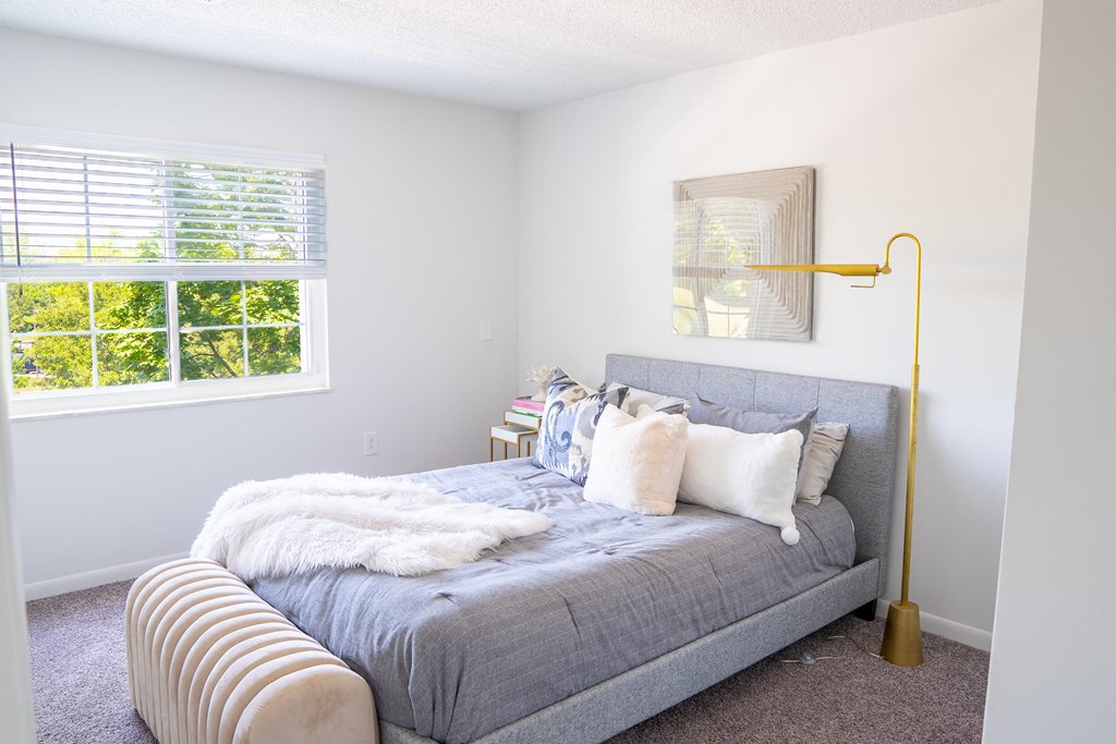 a bedroom with a bed and a lamp