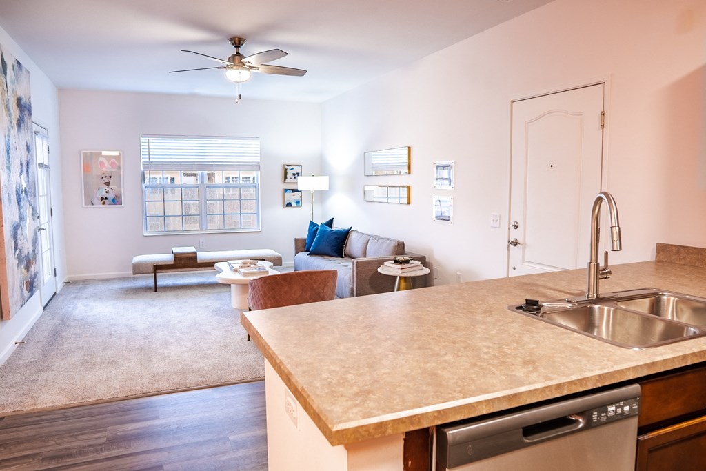 a kitchen with an island and a living room in the background  at Waterstone Landing, Perrysburg, 43551