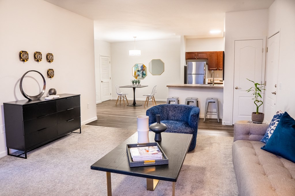 a living room with a couch coffee table and a kitchen in the background at Waterstone Landing, Perrysburg, OH