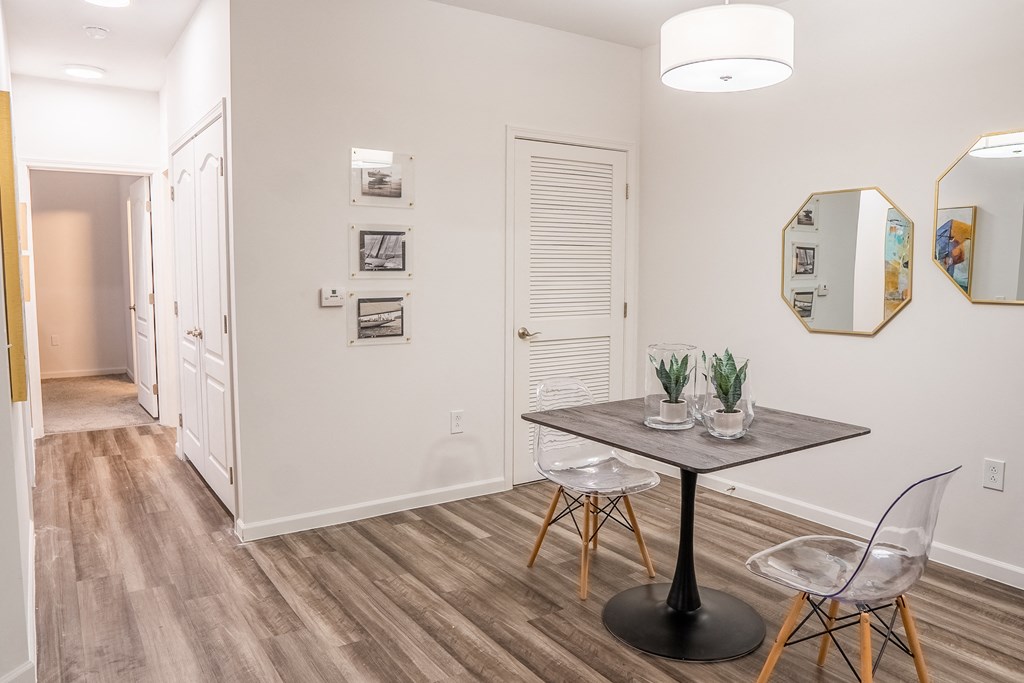 a dining area with a table and chairs and a hallway in the background  at Waterstone Landing, Ohio, 43551