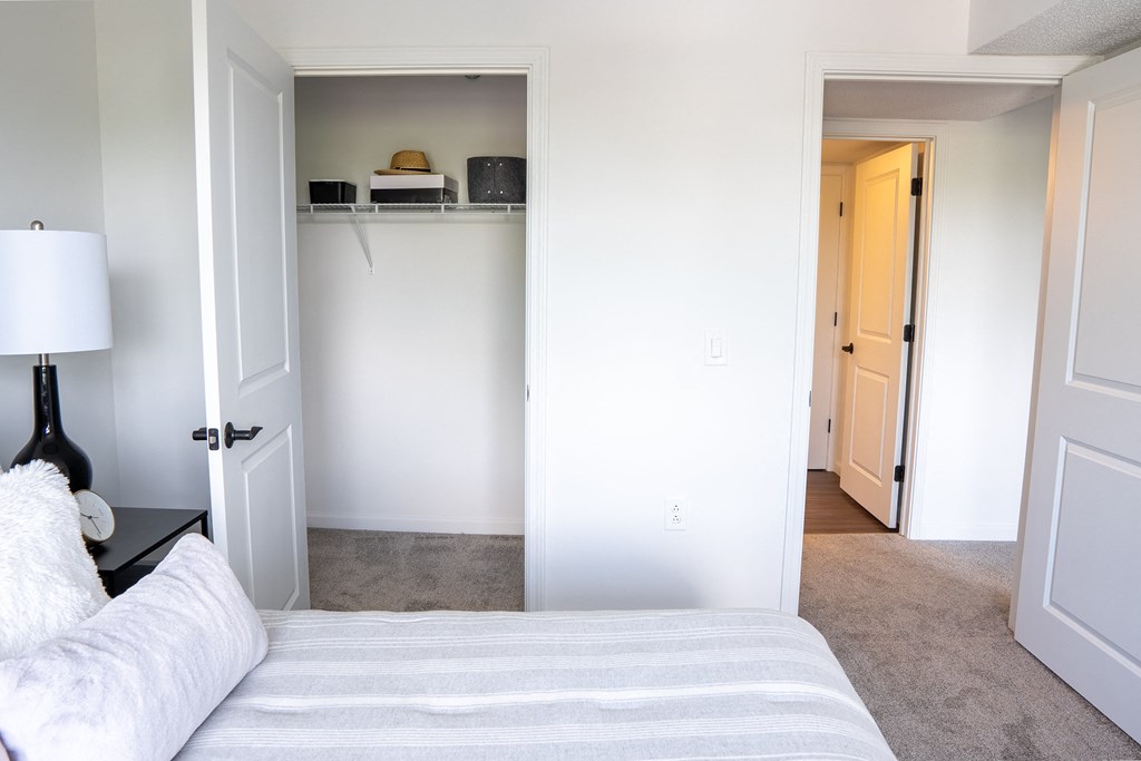 a bedroom with white walls and a white couch