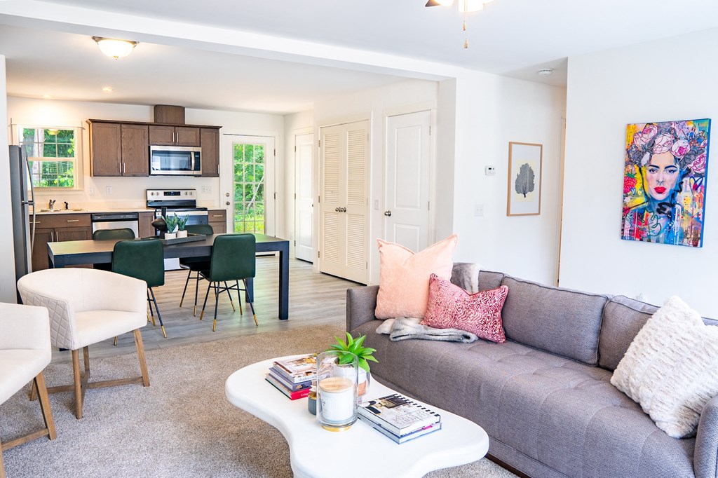 a living room with a gray couch and a white coffee table