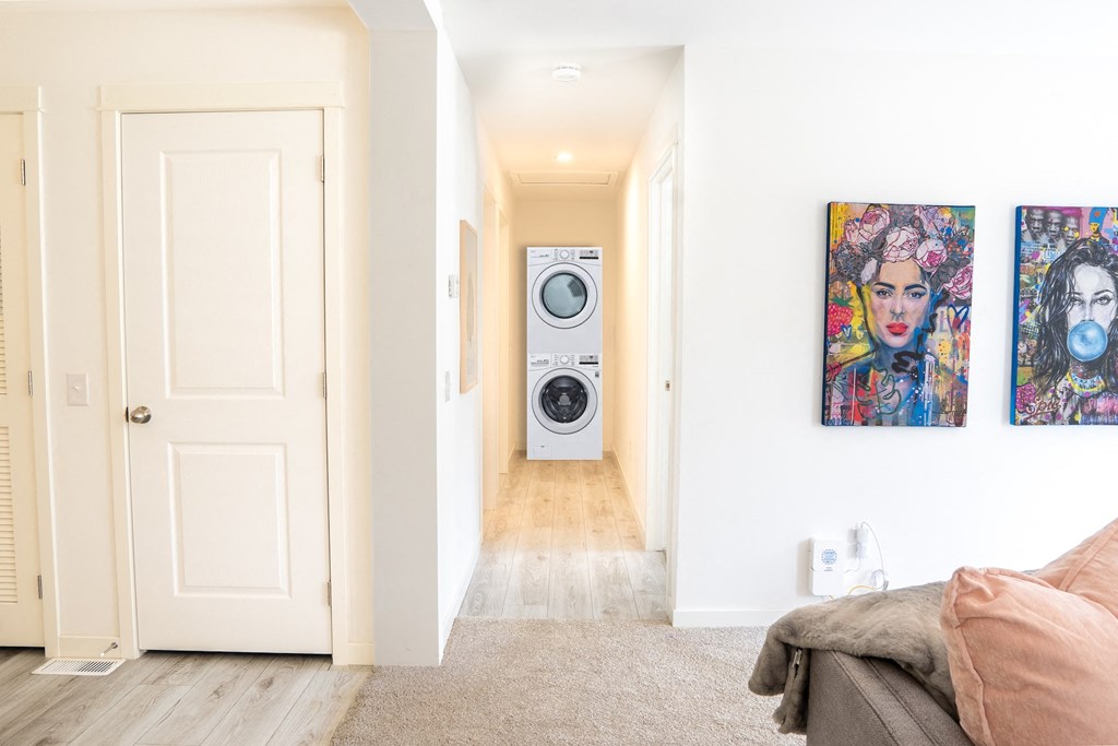 a room with a washing machine and a washer and dryer