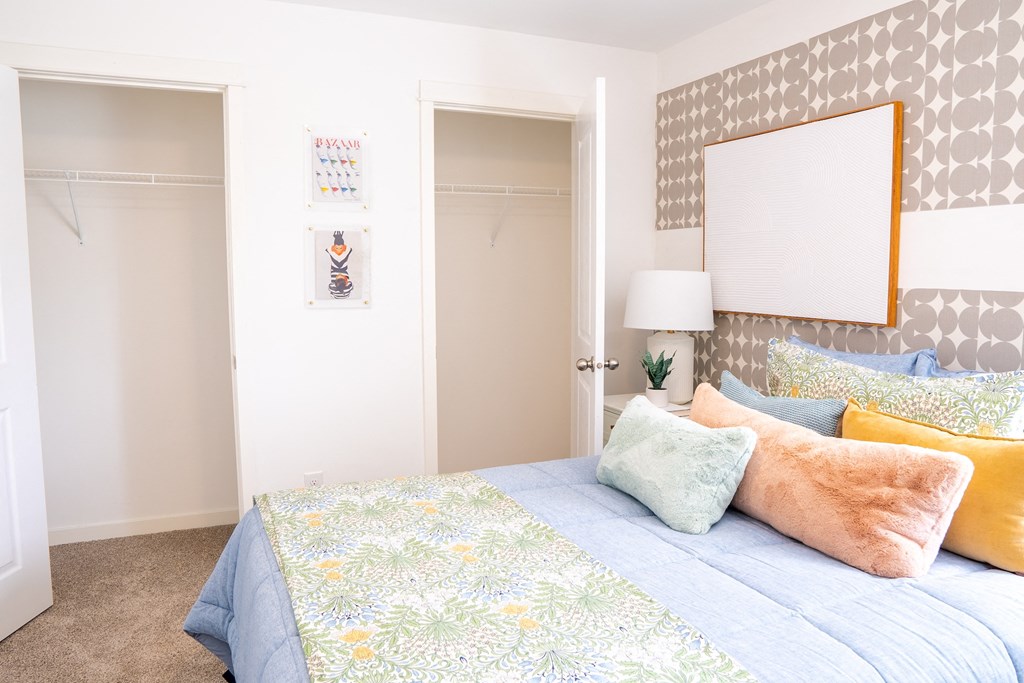 a bedroom with a bed and two closets