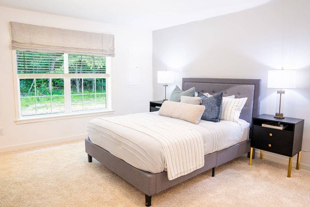 a bedroom with a bed and two nightstands