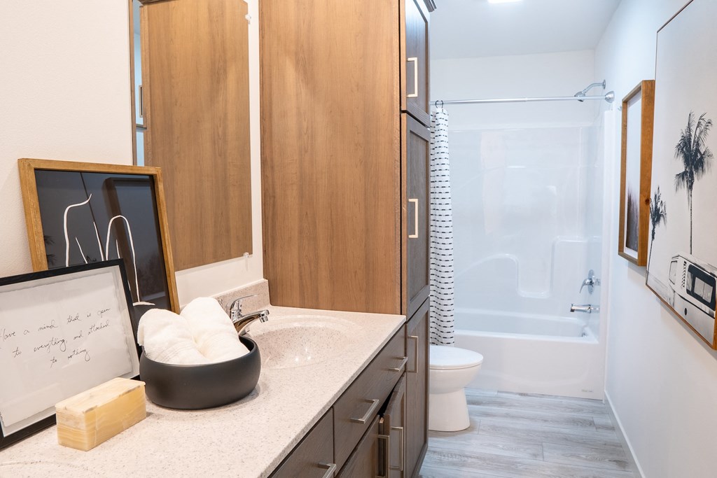 a bathroom with a white toilet next to a bathtub with a shower curtain