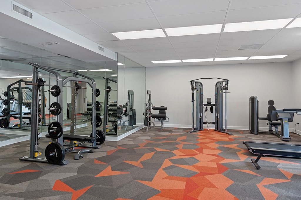 A gym with orange and grey floor tiles.