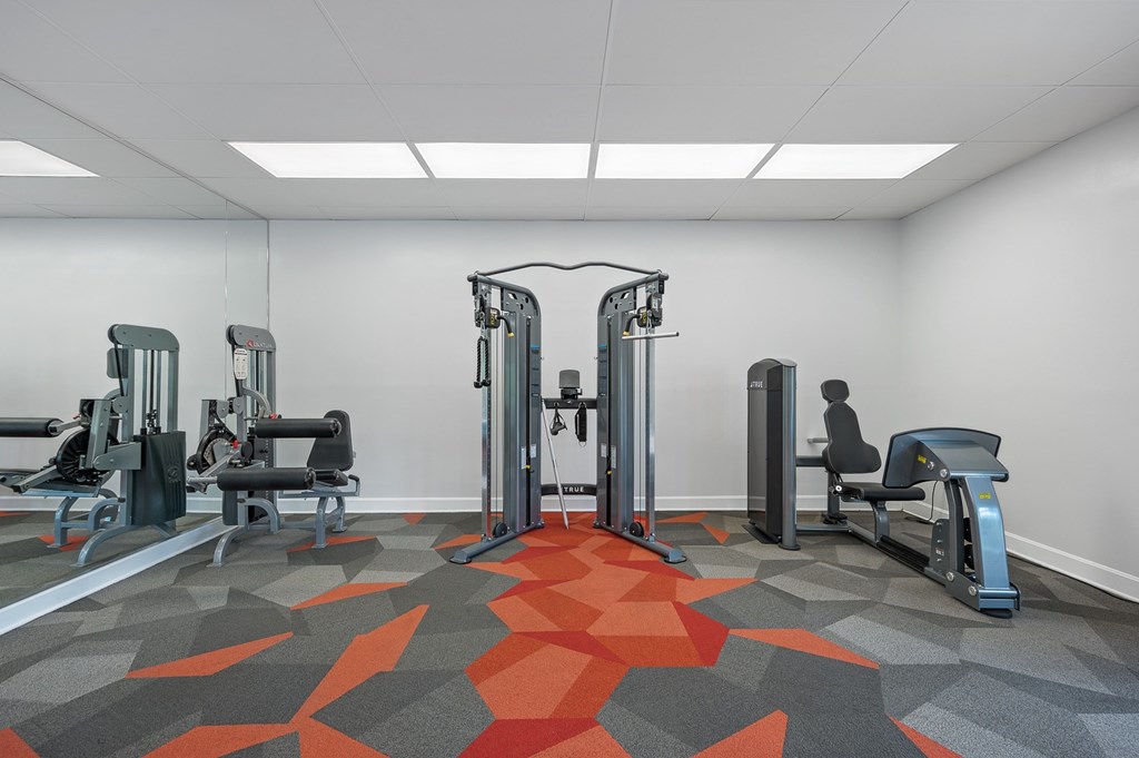 A gym with a variety of equipment including a leg press machine.