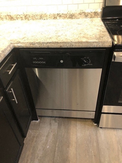 a kitchen with a stainless steel dishwasher