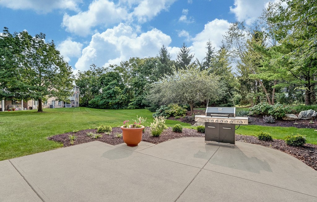 Community patio with grill and beautifully landscaped!