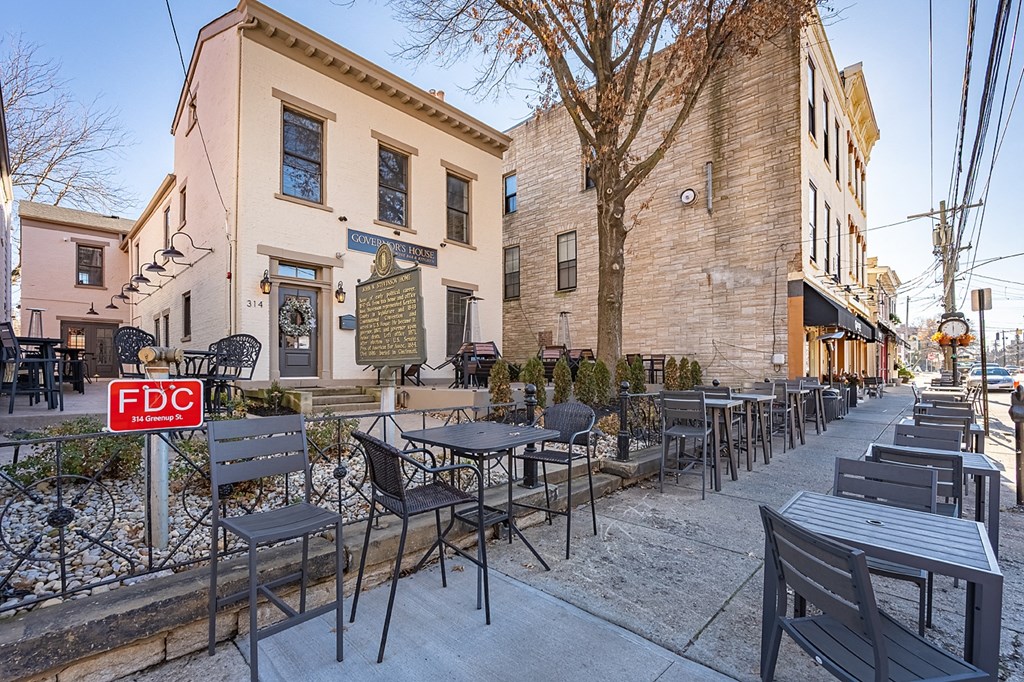 the outside of a restaurant with tables and chairs on the sidewalk