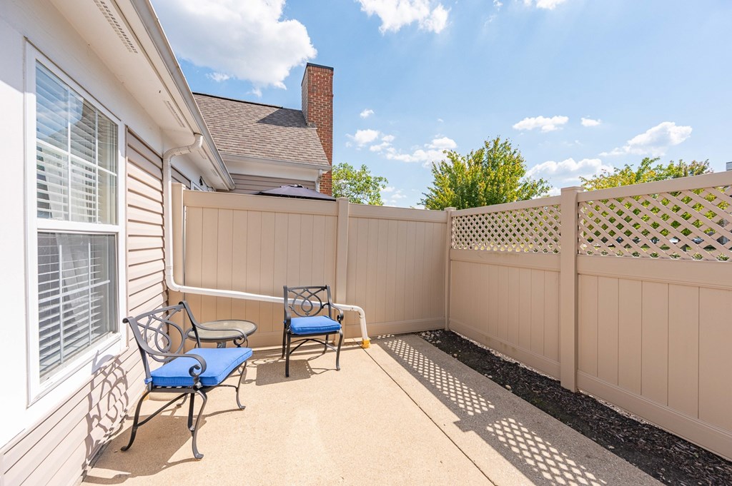 A patio with a table and two chairs.
