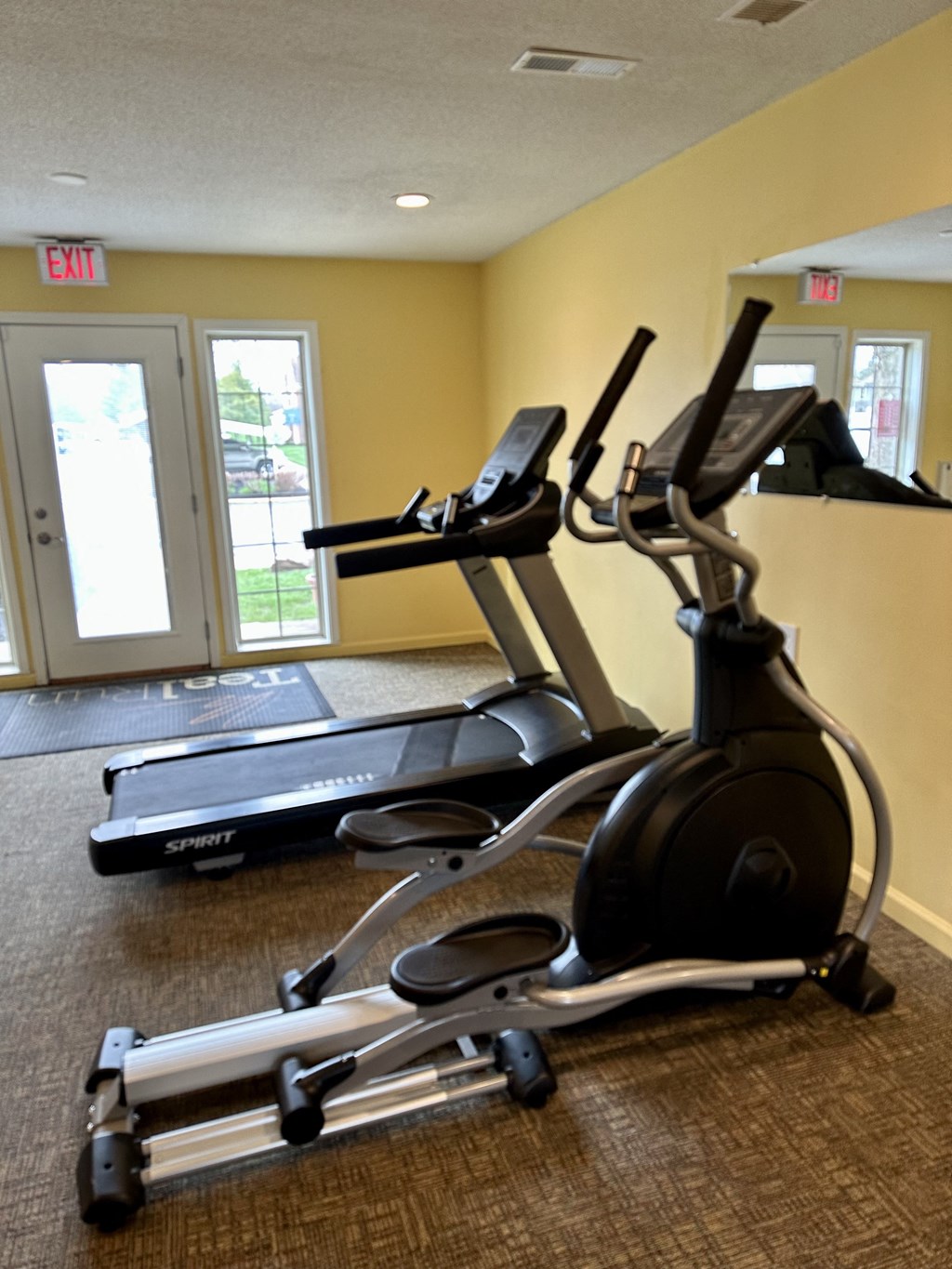 a room with a lot of exercise equipment