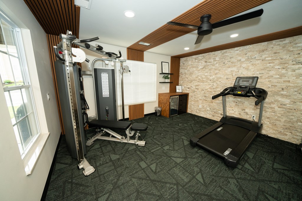 Home gym with exercise equipment and a window at Honey Creek, 46143