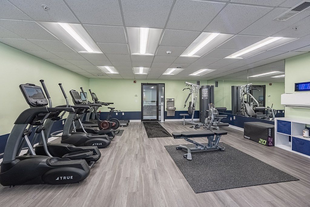 a gym with cardio machines and other exercise equipment