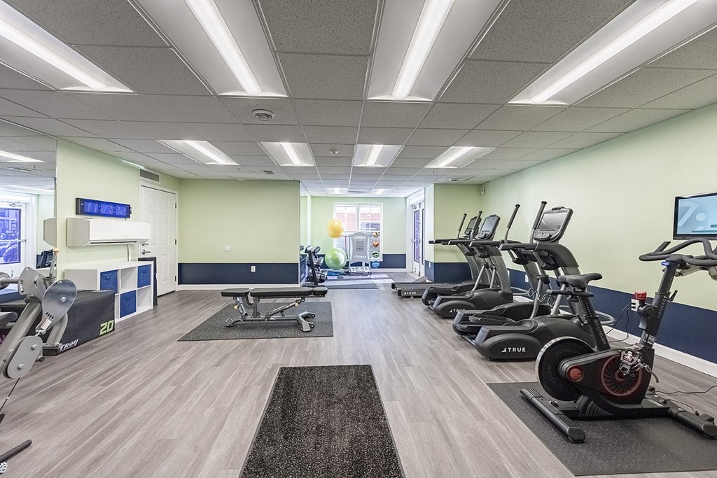 a gym with cardio machines and other exercise equipment