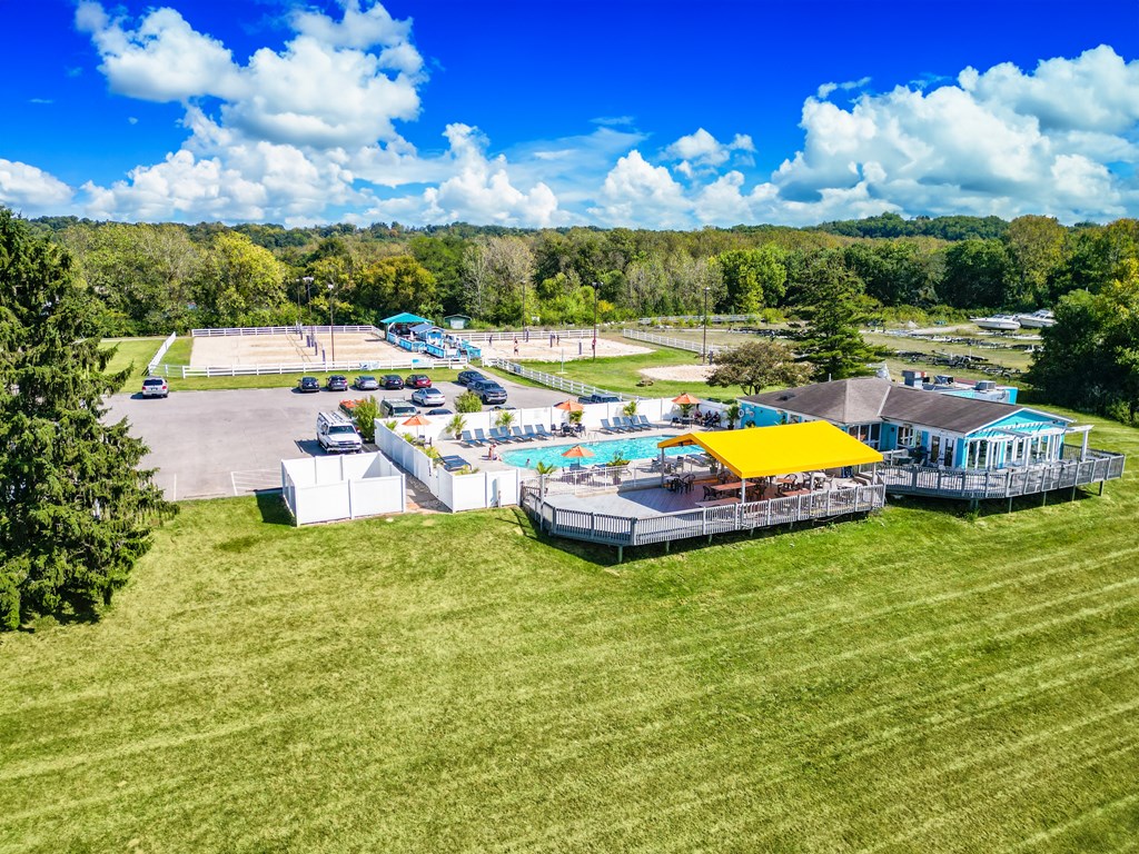 a aerial view of a resort with a pool and a parking lot